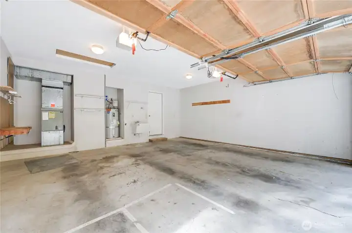 The over-size garage has a utility sink, and houses the hot water heater and the furnace. There is only one step into the condo from the garage, which conveniently leads into the utility room.