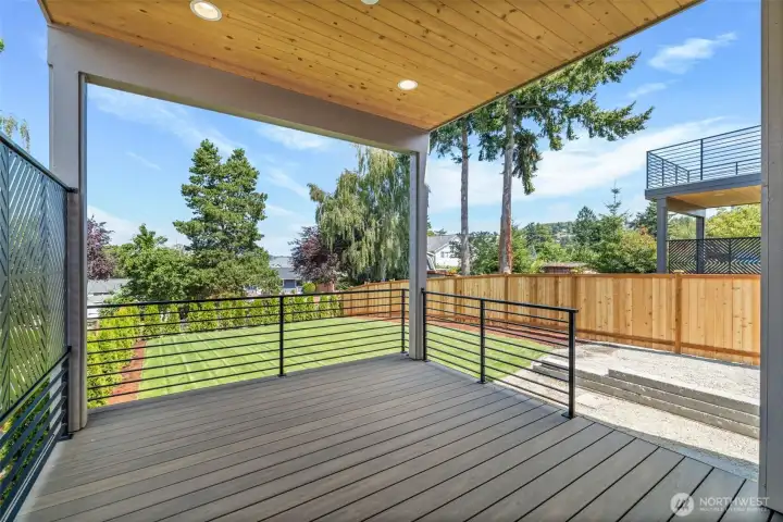 Main level deck off dining room & overlooking beautiful landscaping.