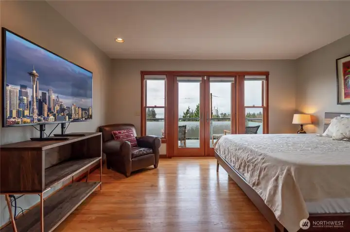 Primary bedroom has patio doors that lead to deck.