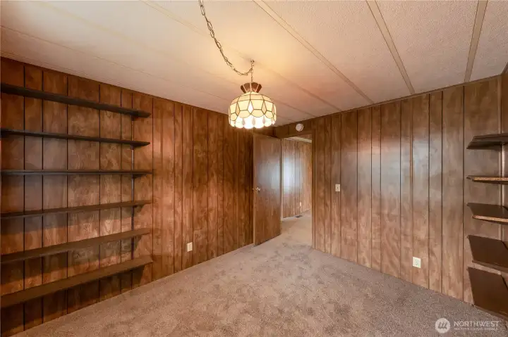 This bedroom is brightened up by the large window.