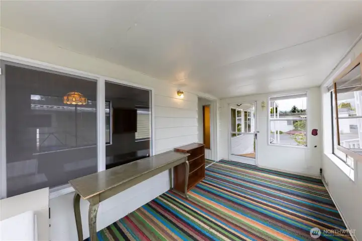 The front porch enters into the fully enclosed sun room, a perfect space for relaxing.