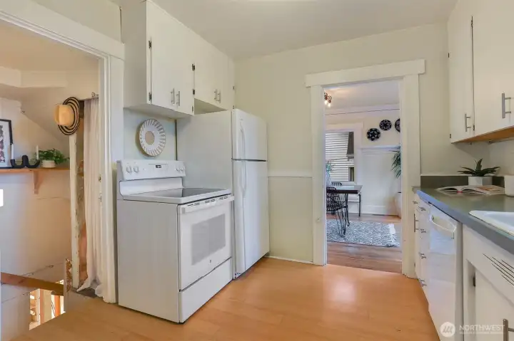 White on white, stove, range, refrigerator and dishwasher.