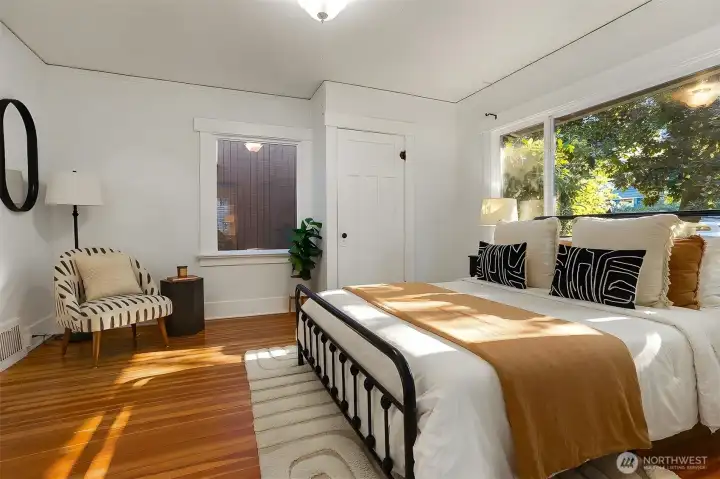 Main floor bedroom with double pane windows and lovely wood floors.  Two closets in this space.
