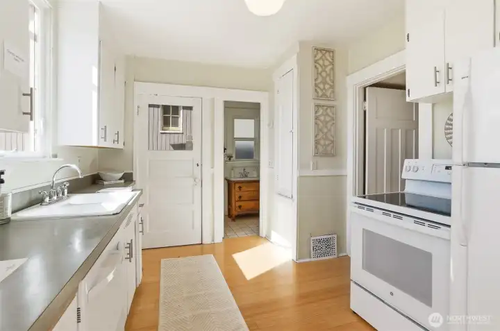 White on white, stove, range, refrigerator and dishwasher.