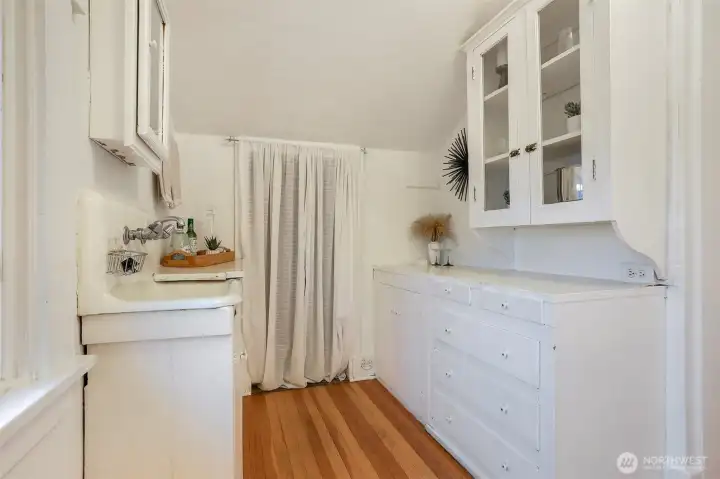 Sweet kitchenette setup—perfect as a coffee bar or inviting guest space.