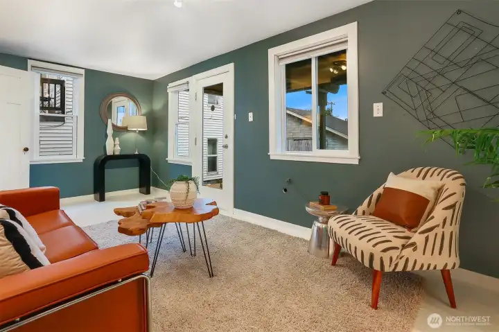 Daylight lower-level rec room with a private entrance offers a flexible opportunity to create comfortable guest quarters.