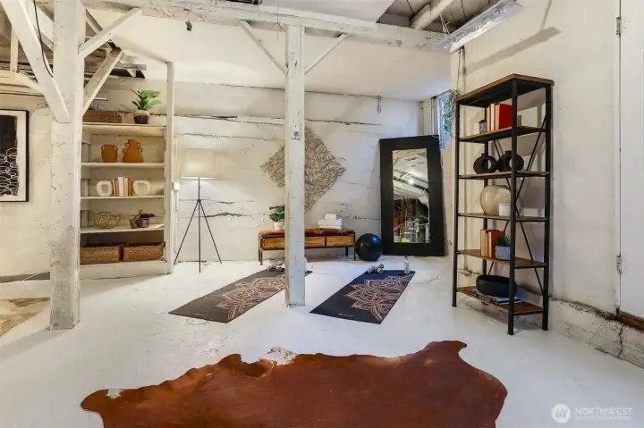 The unexpected surprise! An expansive lower level with soaring ceilings, ready to be finished to suit your needs. Art studio, home gym, or a unique rental space with private exterior access.