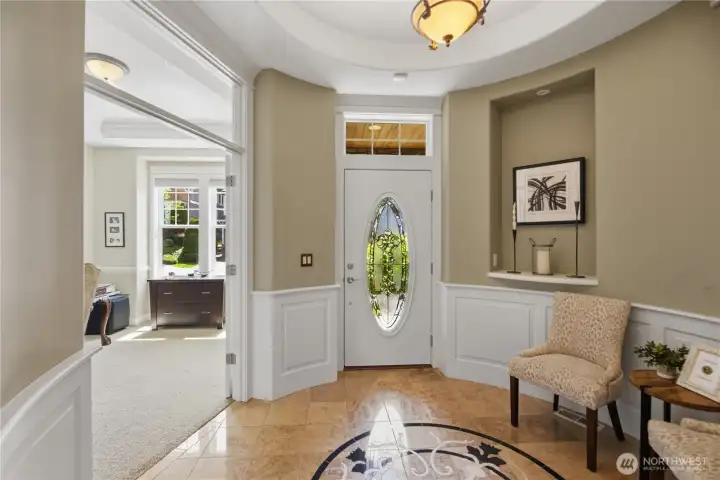 Grand tile rotunda entry with art niches and elegant cove ceiling creates a memorable first impression.