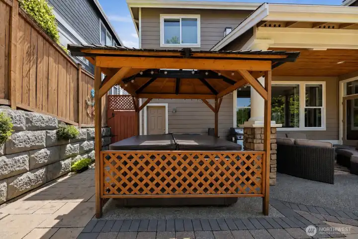 Covered patio with upgraded columns and an extended patio pad designed for a therapeutic hot tub.