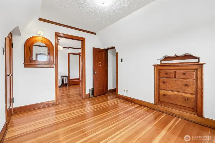 How enchanting is this room? Built-in dresser, built-in cabinet, closet plus doors to two adjacent bedrooms.