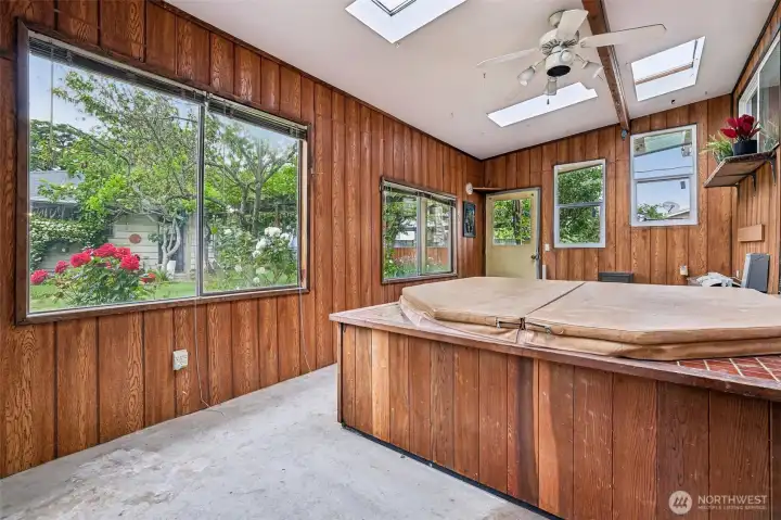 Enclosed room for the hot tub with skylights & windows out to the private backyard.