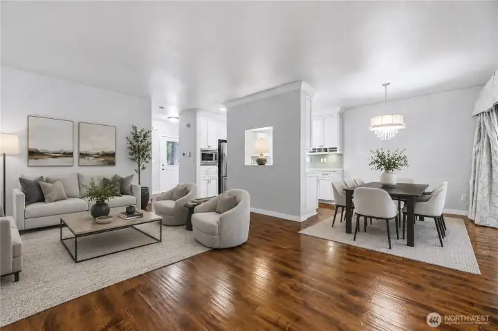 Virtually staged living and dining areas highlighting the open-concept on the main floor.