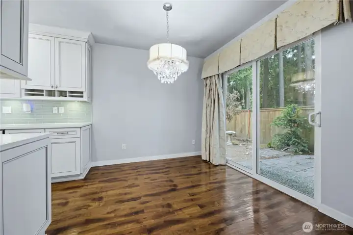 Bright dining area right off the kitchen, complete with a sliding glass door to the patio.