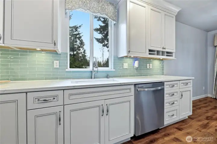 Enjoy a peaceful view of the trees and spacious lawn right from the kitchen sink.