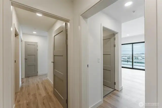 Hallway entry looking into both second bedroom and primary room.