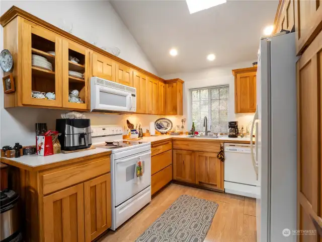 Light bright kitchen with vaulted ceilings and skylight