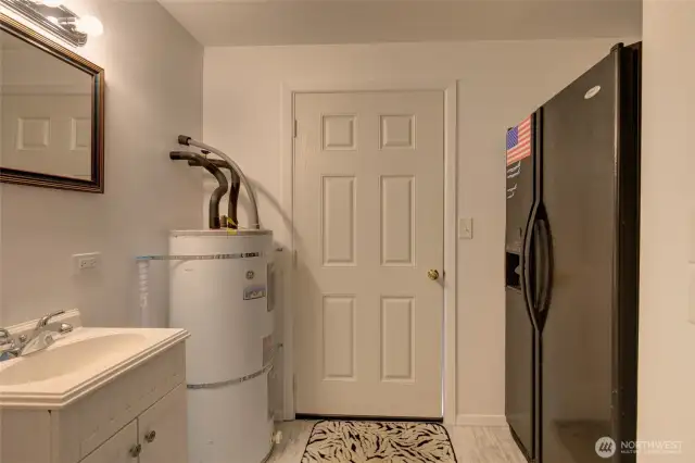 There is space for stackable laundry in lieu of the existing fridge.