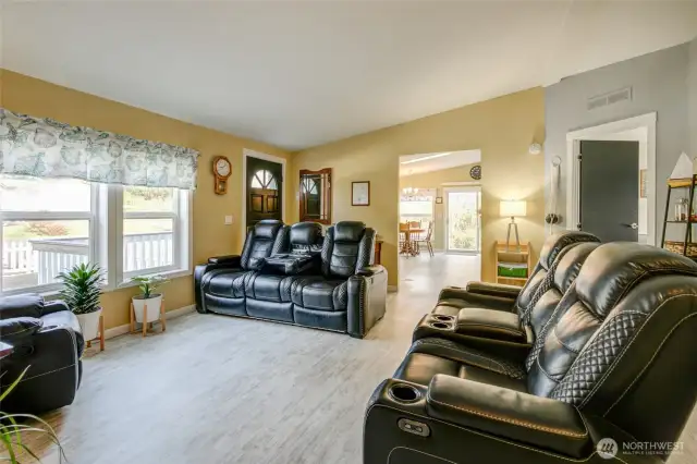 To the left of the front door, is access to the kitchen and dining area, and the primary suite is straight ahead.