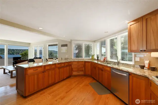 Spacious chef's kitchen with granite countertops, designer tile, breakfast bar, stainless steel appliances, and African Mahogany cabinets. All appliances stay.