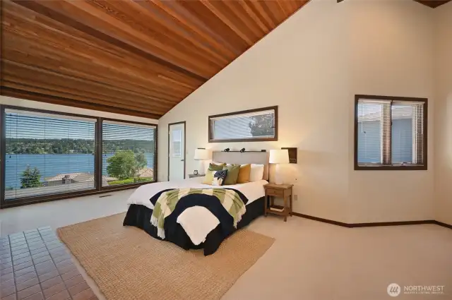 Generously sized primary suite with huge sitting area, gas fireplace, oversized walk-in closet, bath with 5-piece vanity, and breathtaking views.