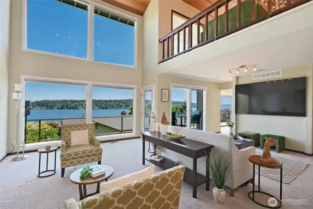 Gorgeous light-filled living area offers great entertaining potential. Cathedral ceilings, exposed beams, gas fireplace, and picture windows allow for maximum sunlight and stunning panoramic views of the lake and mountains.