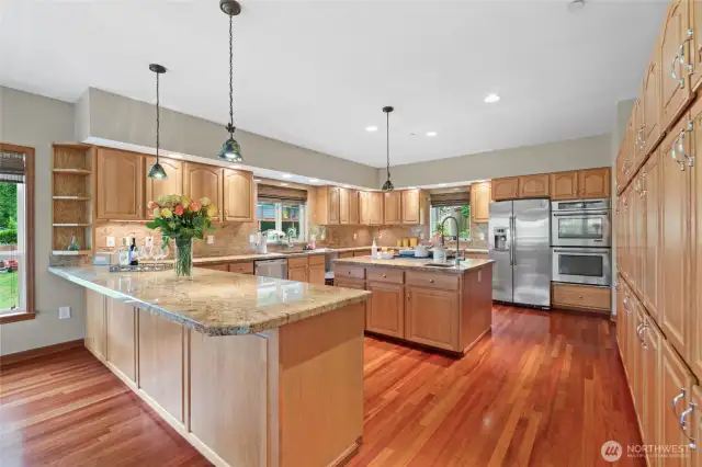 The kitchen is complete with stainless appliances, granite counter tops, a bar sink, and tiffany downlights