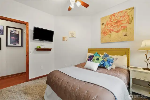 Down the hall from the primary bedroom and across the hall from a full bath sits this bright, light 2nd bedroom