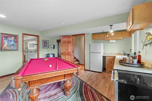 The daylight basement unit has a small kitchen, a full bathroom and laundry, a living room, a bedroom, and a large walk in closet