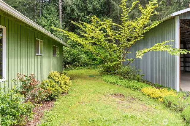 Back patio leading to established high end garden beds