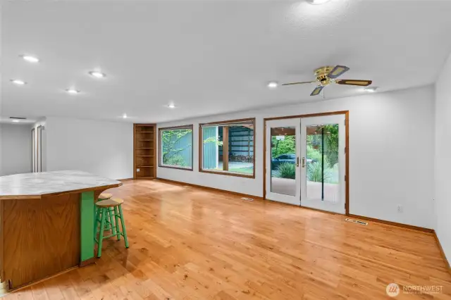 Oversized dining and living area off kitchen   with french doors leading to covered patio.