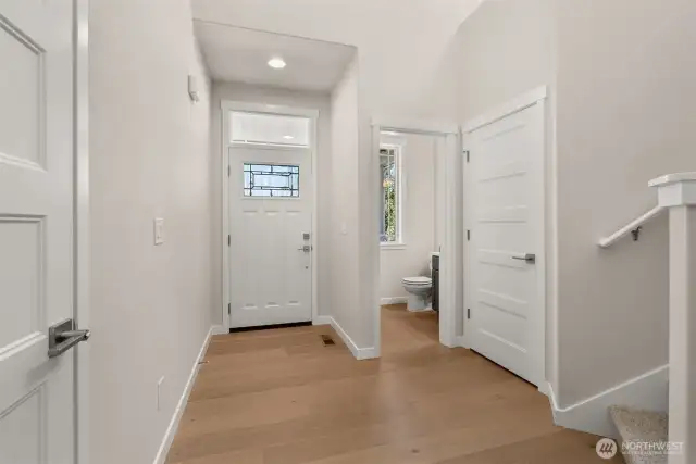 Light and bright entryway with vaulted ceilings and hardwood floors greet you upon entering.