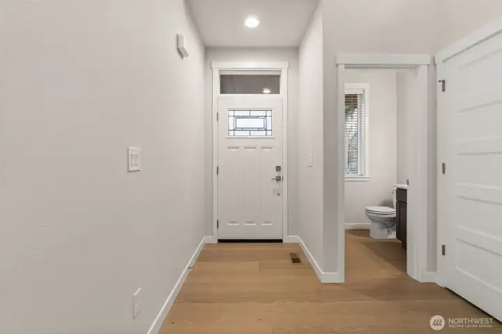 Light and bright entryway with vaulted ceilings and hardwood floors greet you upon entering.