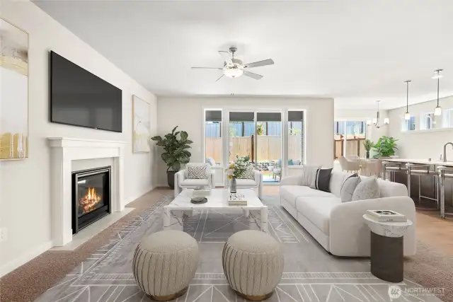 Virtually staged photo of living room that opens to kitchen & dining room