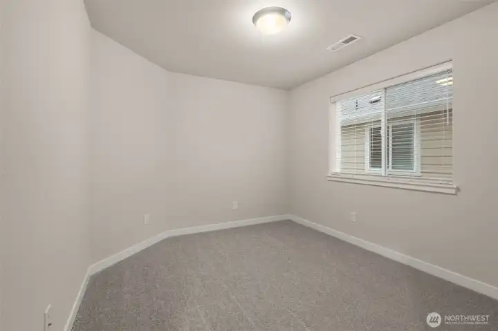 Third bedroom on upper floor features a walk-in closet