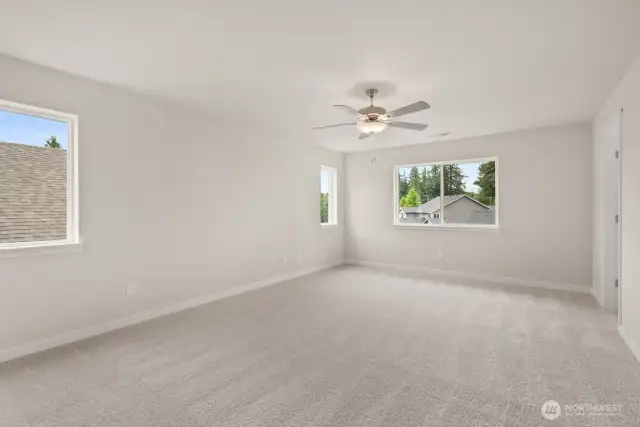 Spacious primary bedroom offers walk-in closet and 5-piece bath