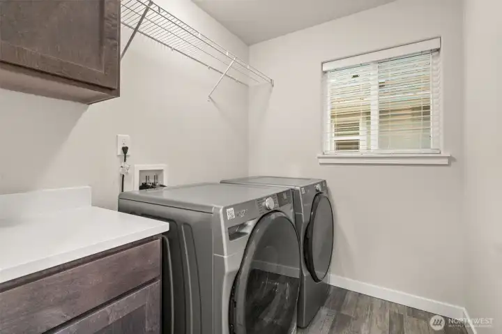 Light and bright laundry room on the second floor. Features an upper and lower cabinet plus quartz countertop.  Washer and Dryer included.