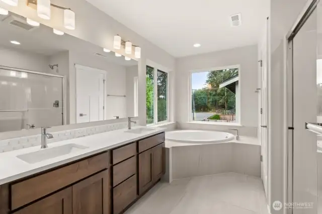 Quartz counters, tile floors, backsplash and oversized soaking tub. A 5-piece primary bath to love!