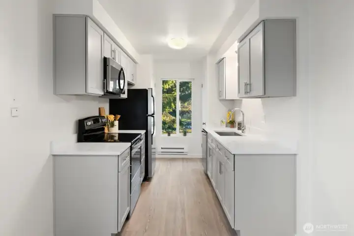 Kitchen has a closets on either side of window for pantry and storage.