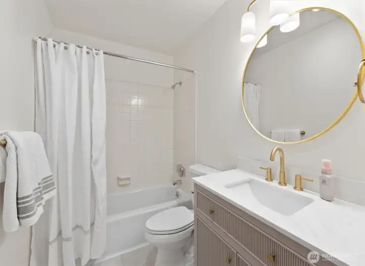 Updated bathroom with new flooring, trim, paint, light and vanity with quart countertop.