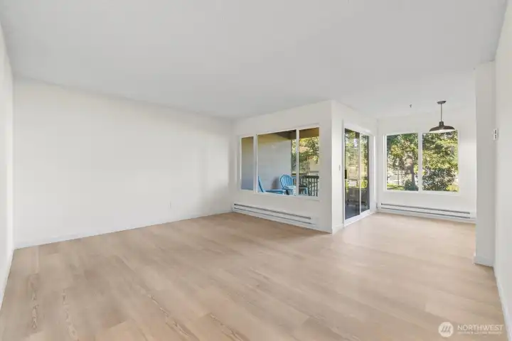 Living and dining room freshly updated with new flooring, trim, paint, heaters and lighting. Such an inviting space.