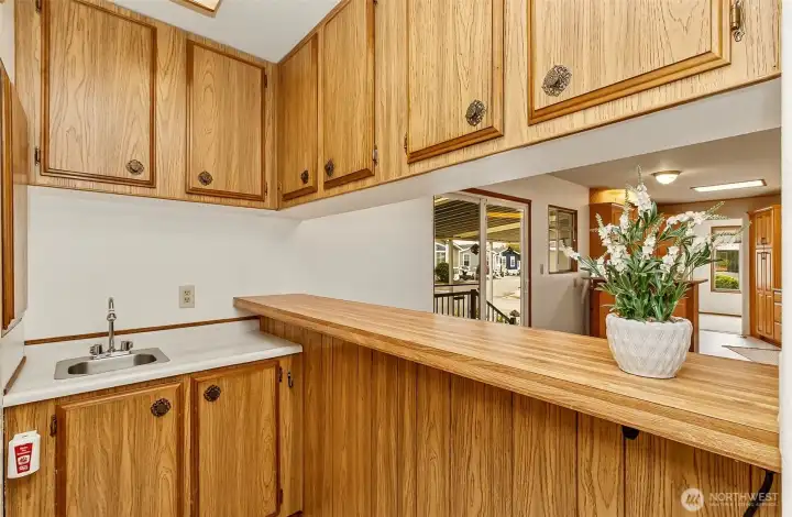 Just off the kitchen- Extra storage with prep-sink and W/D closet.