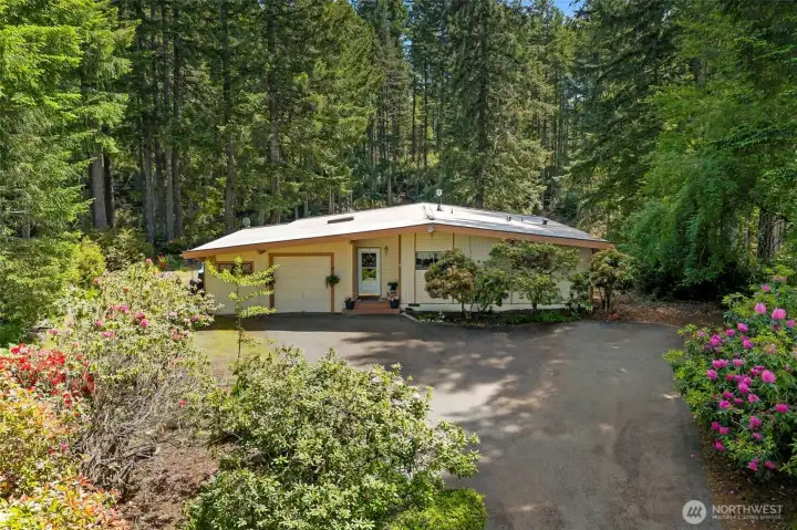 Surrounded by nature and towering trees...plenty of room for RV parking or garage extension