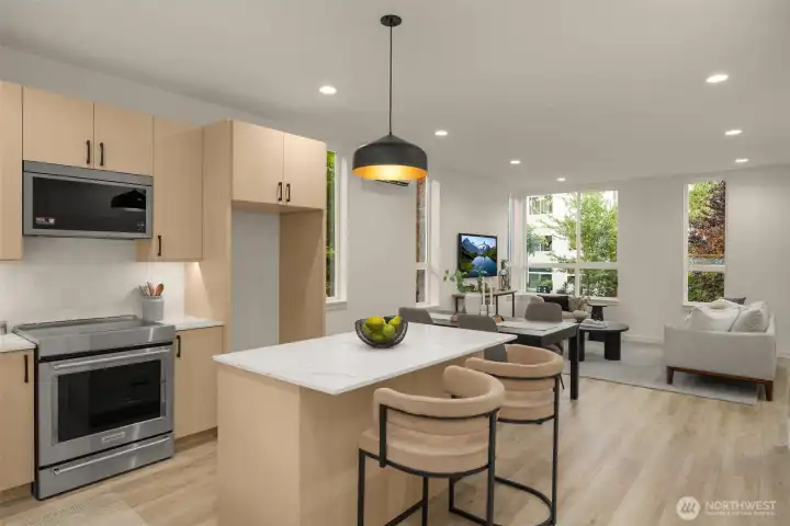 Open-concept layout seamlessly connecting the kitchen to the bright dining and living spaces. (photos are of model home, similar finishes & quality)