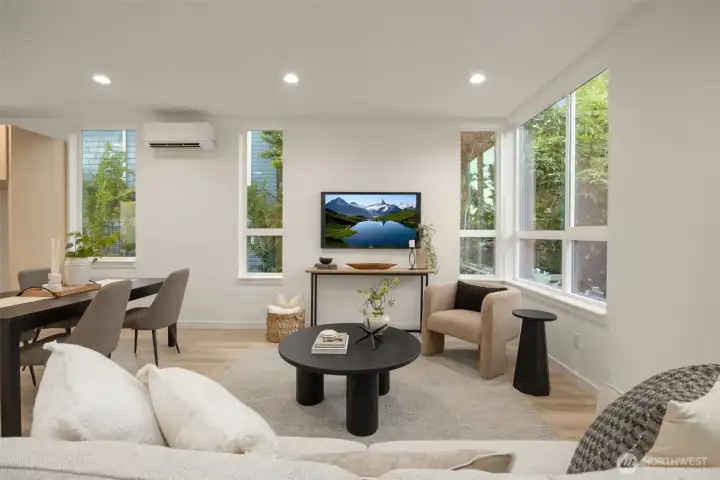Another perspective of the versatile living room space, highlighting the abundance of natural light. (photos are of model home, similar finishes & quality)