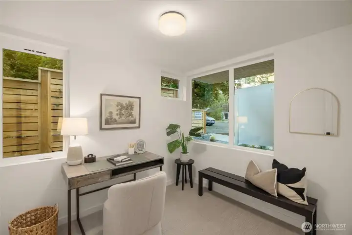 Tranquil bedroom setup featuring a lovely window view looking out into the lush green surroundings. (photos are of model home, similar finishes & quality)