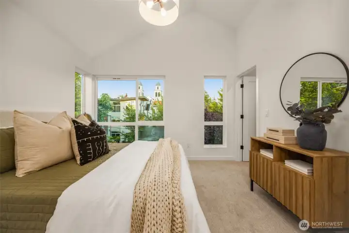 Bright and airy upper-level primary space showcasing beautiful vaulted ceilings and custom architectural angles. (photos are of model home, similar finishes & quality)