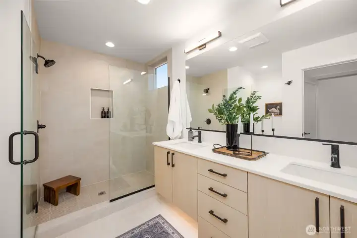 Sleek walk-in closet and dressing area featuring custom built-in storage cabinetry and premium modern finishes. (photos are of model home, similar finishes & quality)
