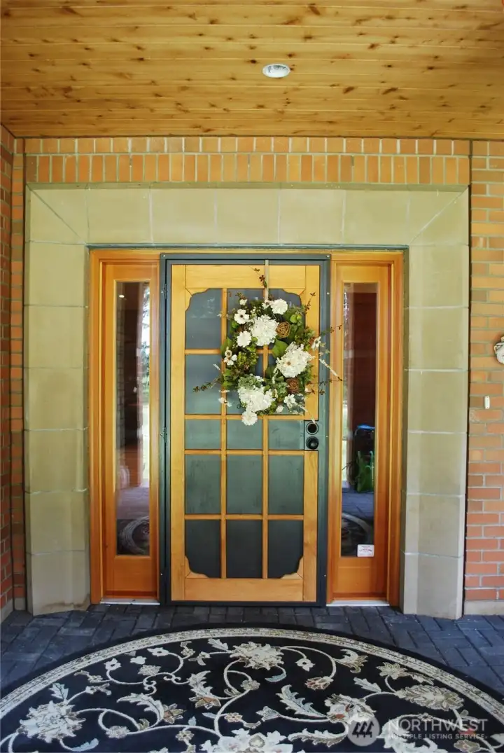 Entry door with executive stone work trim greets guests. Entry door with executive stone work trim greets guests.