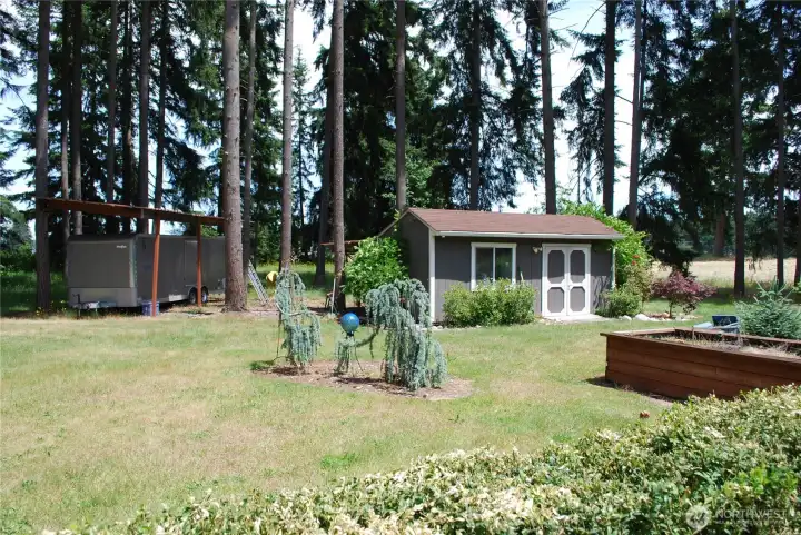 Covered RV parking and fantastic shed and garden area. Covered RV parking and fantastic shed and garden area.
