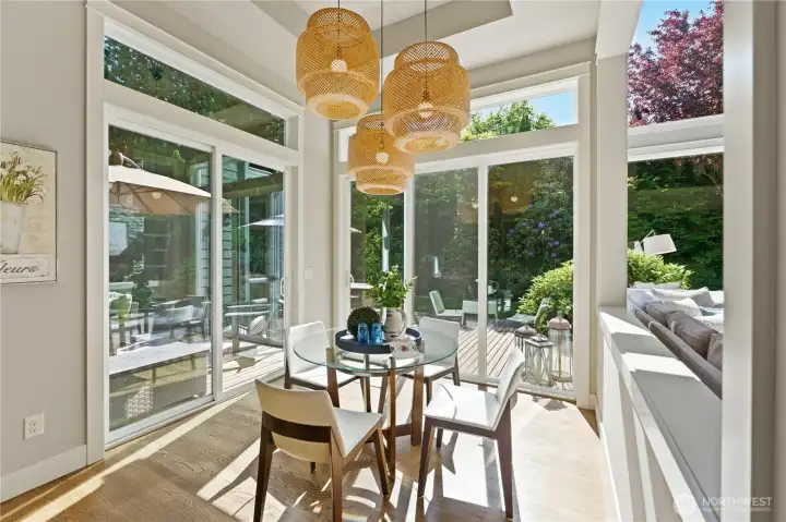 This warm, cozy breakfast nook stays bright even in winter, with two sets of sliders that welcome in the garden and provide easy outdoor access